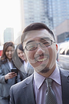 Portrait of smiling businessman outdoors, Beijing