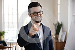 Portrait of smiling businessman point at screen with finger