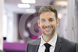 Portrait of smiling Businessman posing in modern office, lookin photo