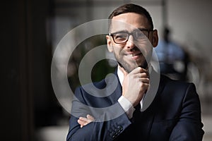 Portrait of smiling businessman posing at office