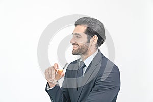 Portrait smiling businessman standing and holding a glass of champagne