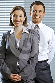 Portrait of smiling businessman and woman in office