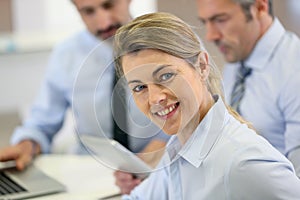 Portrait of smiling businesswoman attending work meeting