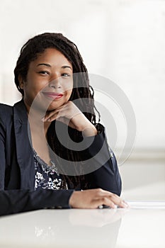 Portrait of smiling businesswoman with dreadlocks, head and shoulders