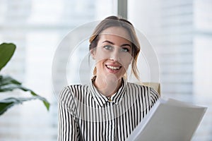 Portrait of smiling businesswoman looking at camera posing photo