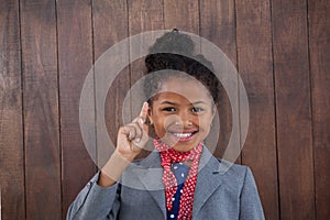 Portrait of smiling businesswoman pointing upwards