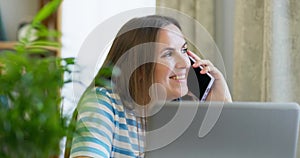 Portrait of smiling businesswoman talking mobile phone in office