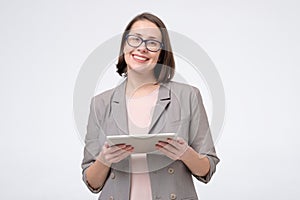 Portrait of a smiling businesswoman using a tablet computer.