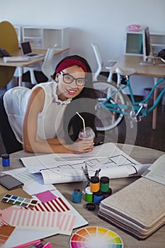 Portrait of smiling businesswoman working in creative office