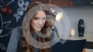 Portrait of smiling businesswoman working laptop computer at remote workplace.