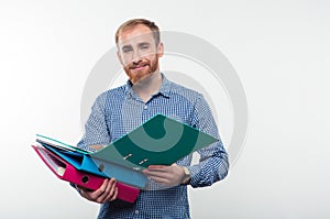 Portrait of a smiling casual man holding folders