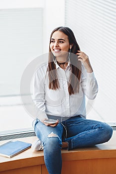 Portrait of smiling Caucasian brunette young beautiful girl woman model with long dark hair and brown eyes