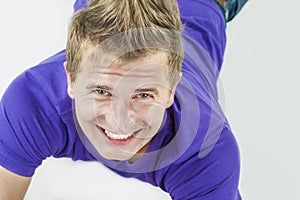 Portrait of Smiling Caucasian Handsome Man Laying on Floor and L