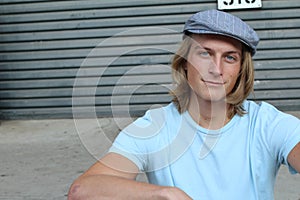 Portrait of a smiling Caucasian man in newsboy hat looking to camera with copy space photo
