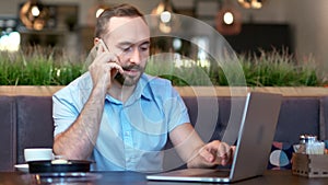 Portrait of smiling Caucasian man teamleader having business conversation talking using smartphone