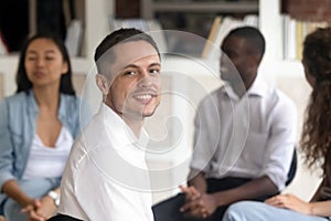 Relieved Caucasian man posing at group therapy session photo