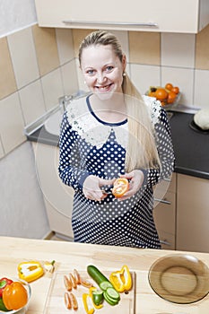 Portrait of Smiling Caucasian Pregnant Woman Making Salad with Vegetables on Kitchen
