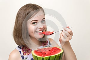 Portrait of smiling caucasian woman girl eating red cut watermelon in her hand. Healthy lifestyle, fruit vegetarian diet.