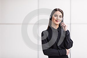 Portrait of smiling cheerful customer support phone operator in headset