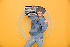 Portrait of a smiling cheerful girl dressed in denim jacket