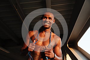 Portrait of a smiling cheerful half naked african sportsman