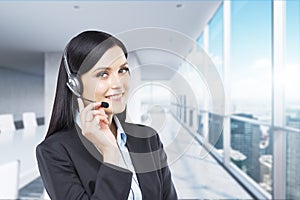 Portrait of smiling cheerful support phone operator in headset.