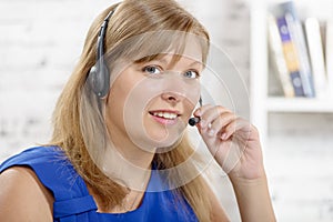 Portrait of smiling cheerful support phone operator in headset.