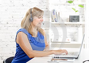 Portrait of smiling cheerful support phone operator in headset.