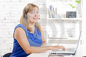 Portrait of smiling cheerful support phone operator in headset.