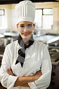 Portrait of smiling chef head standing with arms crossed