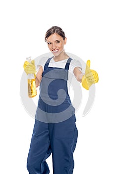 portrait of smiling cleaner with cleanser in hand showing thumb up