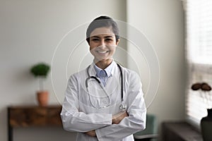 Portrait of smiling confident young indian female doctor.