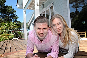 Portrait of smiling couple in front of their new home