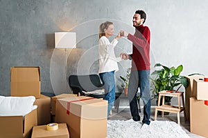 Portrait of a smiling couple moving together in a new house