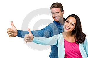 Portrait of smiling couple showing thumps up sign