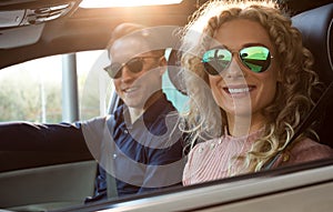 Portrait of smiling couple sitting in car