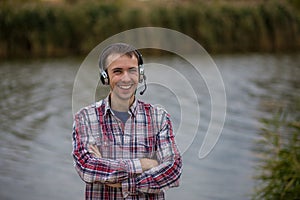 Portrait of a smiling customer service operator wearing a headset