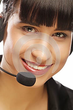 Portrait of smiling customer support female phone worker, over w