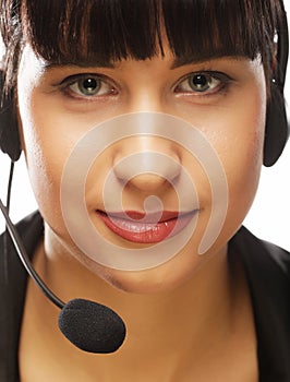 Portrait of smiling customer support female phone worker, over w