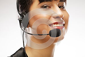 Portrait of smiling customer support female phone worker, over w