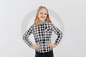 Portrait of smiling cute teen girl with fair-haired, looking casual, standing over white background in casual shirt