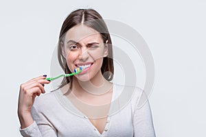 Portrait of a smiling cute woman holding toothbrush. Smiling woman with healthy beautiful teeth holding a toothbrush