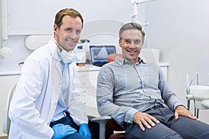 Portrait of smiling dentist and patient