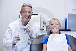 Portrait of smiling dentist and young patient