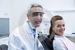 Portrait of smiling dentist and young patient