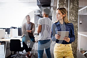 Portrait of a smiling designer, student, freelancer business woman using tablet computer