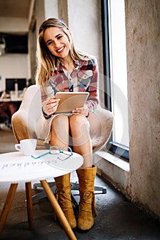 Portrait of a smiling designer, student, freelancer business woman using tablet computer