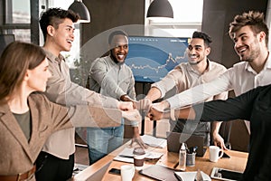 Portrait of smiling diverse business people giving fist bump