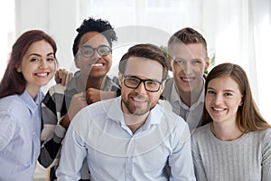 Portrait of smiling diverse millennial team posing together