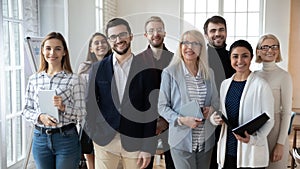 Portrait of smiling diverse team posing together in office